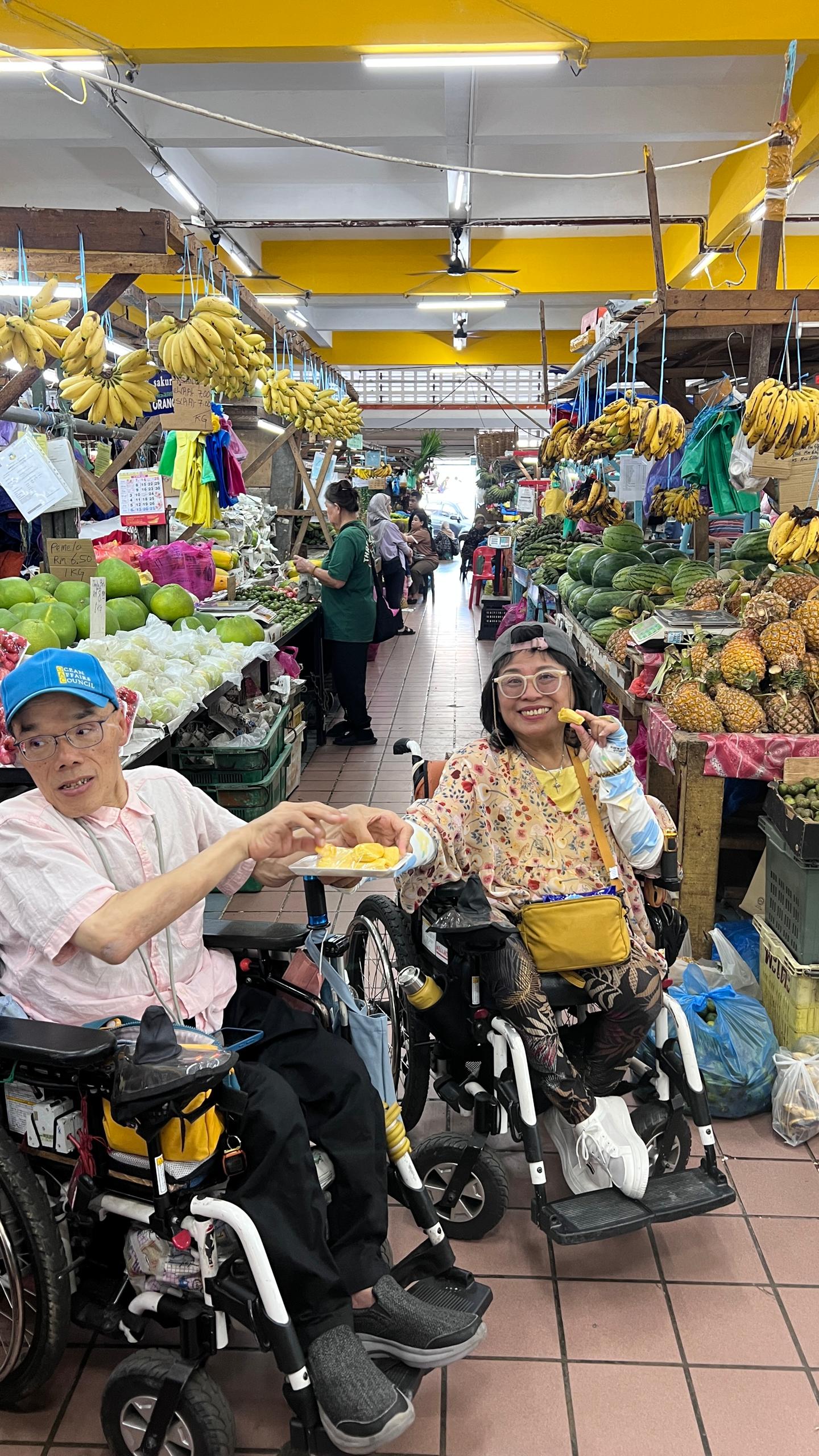 Group with wheelchairs cheering in front of a landmark tower