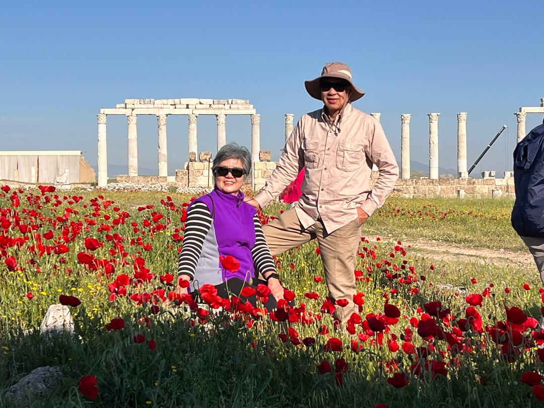 Bro. Quek & Mimi in a poppy field at the ruins of Laodicea, Turkey